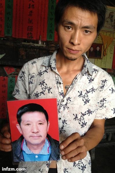 程興貴的兒子程正鵬拿著父親的遺照。程興貴自殺后，政府補償程家6000多塊錢，并終于認(rèn)定了程興貴的代課教齡。 (南方周末記者雷磊/圖)