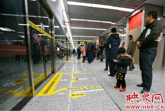 小朋友在等候區(qū)內(nèi)等待地鐵。