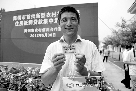 領(lǐng)到貸款，農(nóng)民開心地笑了。